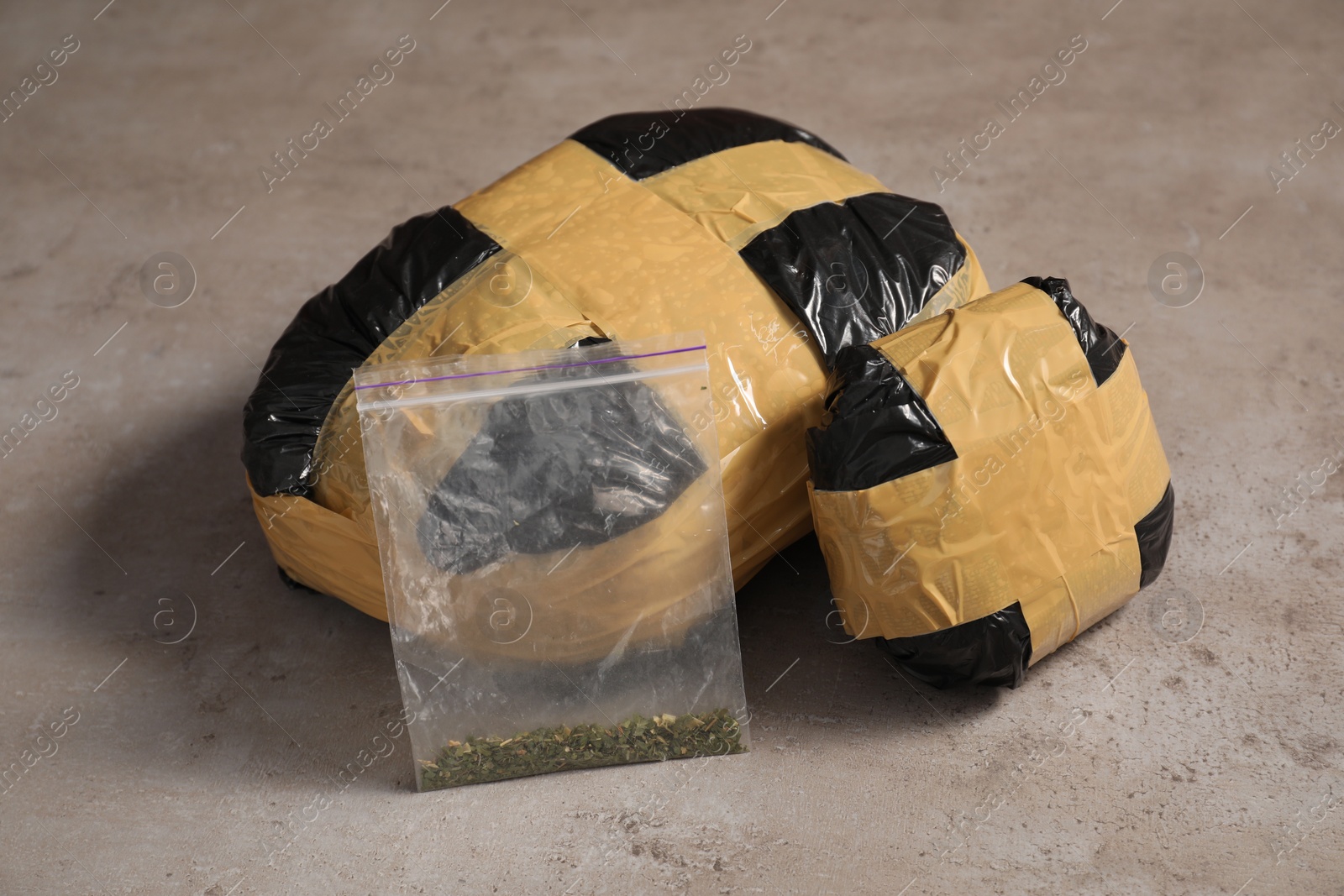 Photo of Packages with narcotics on grey textured table