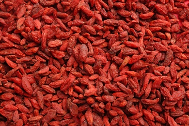 Photo of Many dried goji berries as background, top view. Healthy superfood