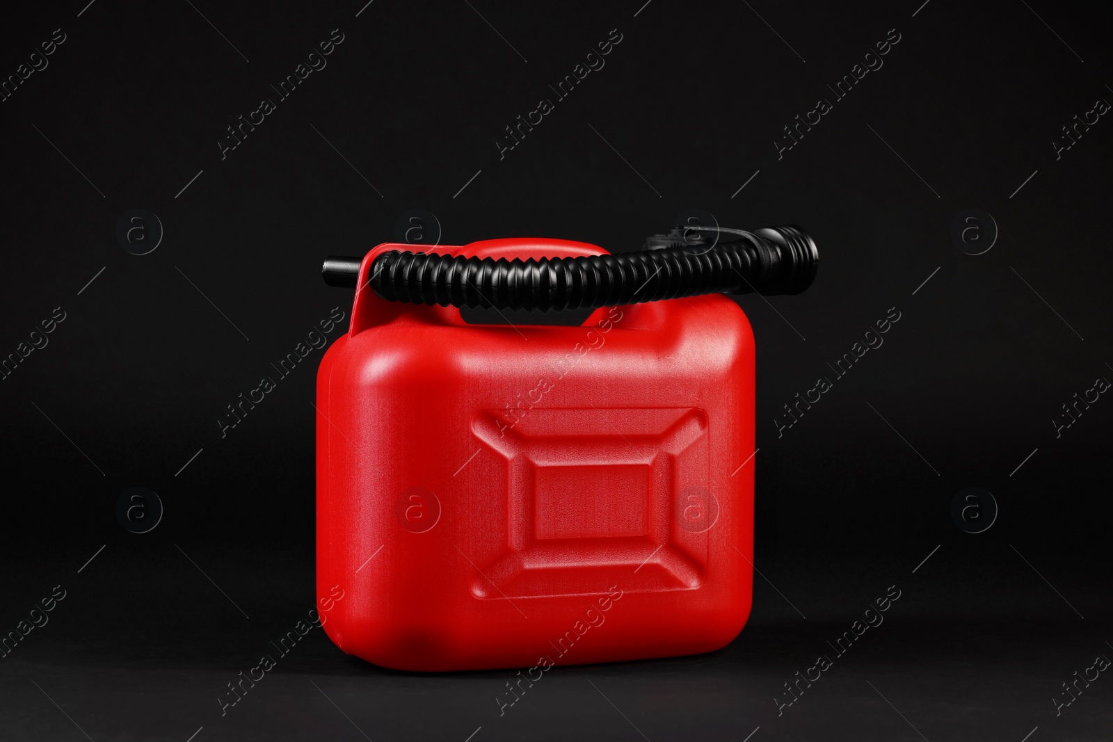 Photo of New red plastic canister on black background