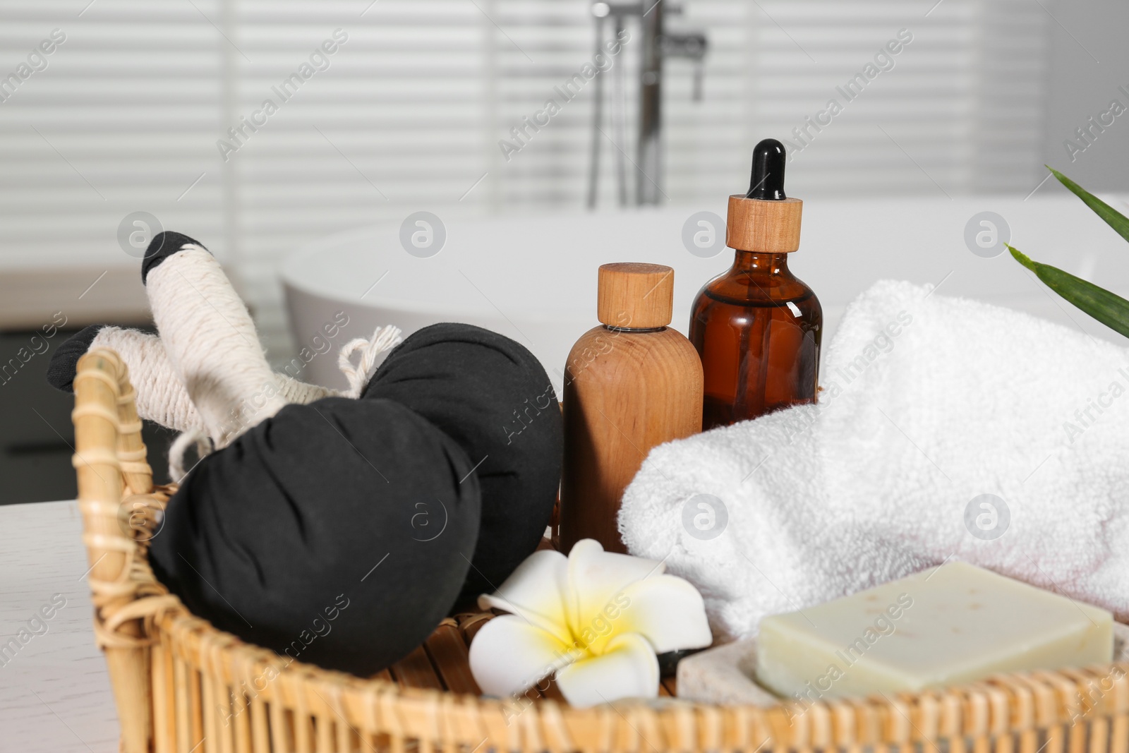 Photo of Beautiful composition with different spa products and flower on table in bathroom, closeup