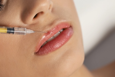 Young woman getting lips injection, closeup. Cosmetic surgery