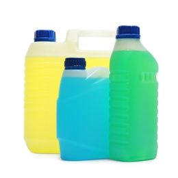 Photo of Plastic canisters with different liquids for car on white background