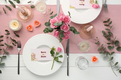 Romantic table setting with flowers and candles, flat lay