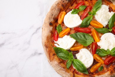 Photo of Delicious pizza with burrata cheese, tomatoes and basil on white marble table, top view. Space for text