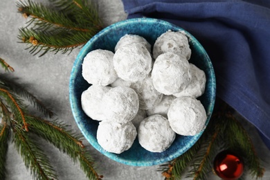 Photo of Flat lay composition with Christmas snowball cookies on grey table