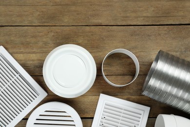 Parts of home ventilation system on wooden surface, flat lay. Space for text