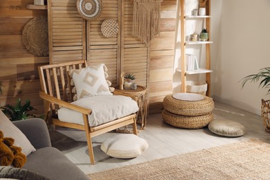 Photo of Stylish living room interior with comfortable wooden armchair and beautiful houseplants