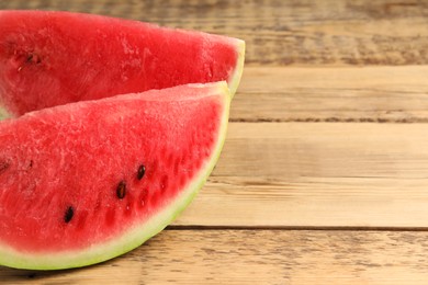 Photo of Delicious fresh watermelon slices on wooden table, closeup. Space for text