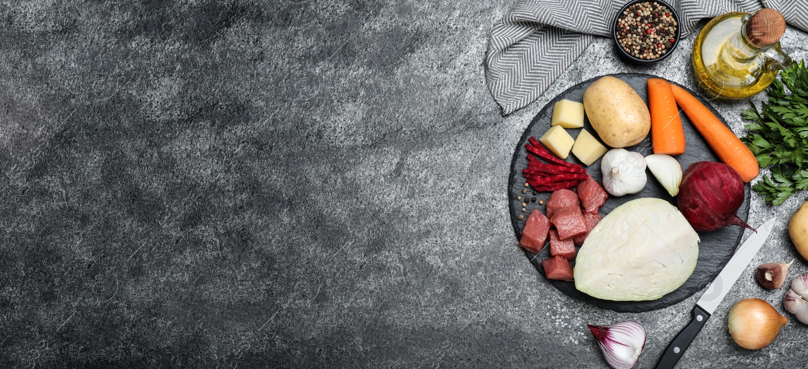 Photo of Ingredients for traditional borscht on grey table, flat lay. Space for text