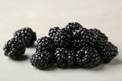 Photo of Pile of tasty ripe blackberries on white table