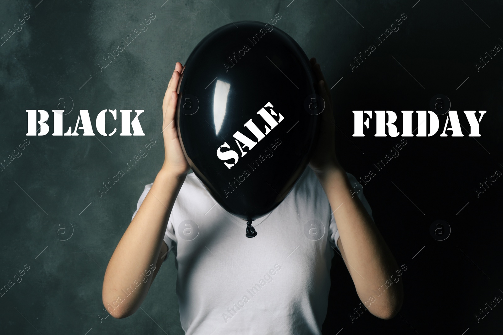 Image of Black Friday concept. Woman holding balloon with text SALE on dark background