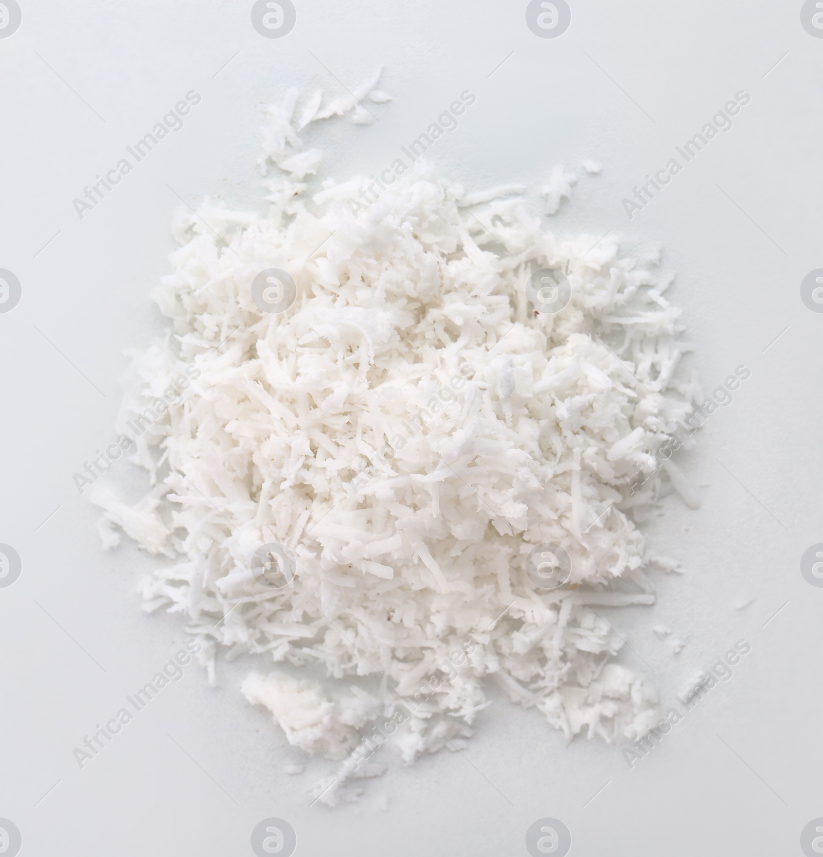 Photo of Fresh coconut flakes on white background