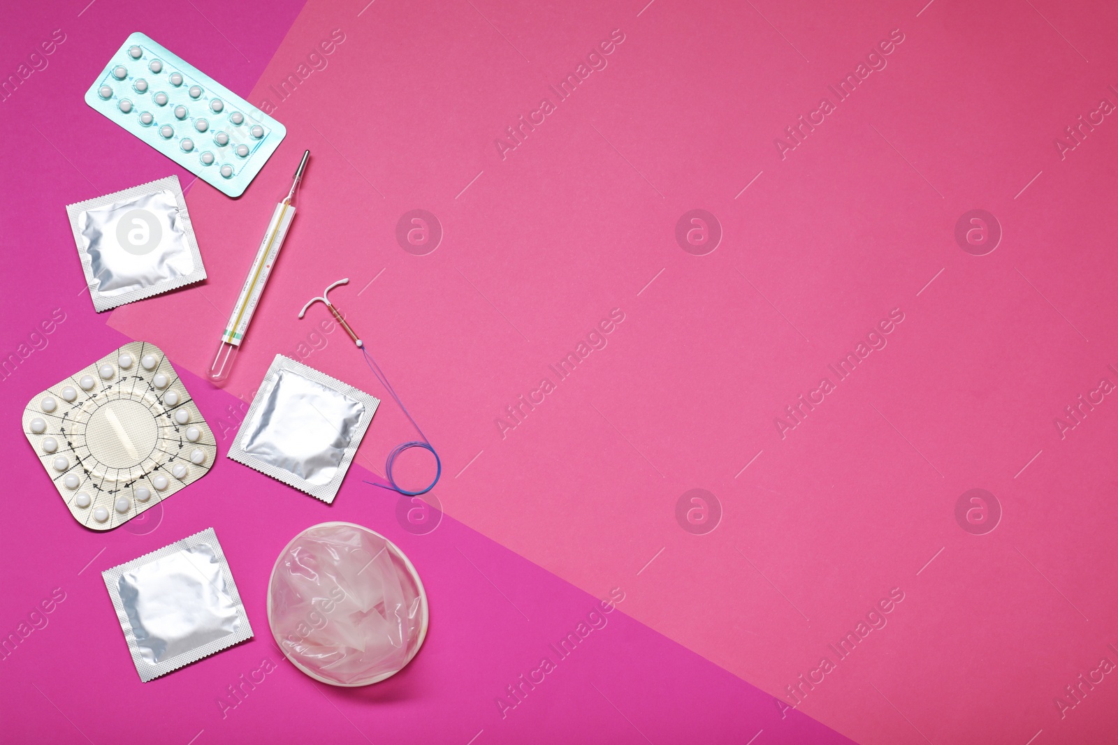 Photo of Contraceptive pills, condoms, intrauterine device and thermometer on color background, flat lay and space for text. Different birth control methods