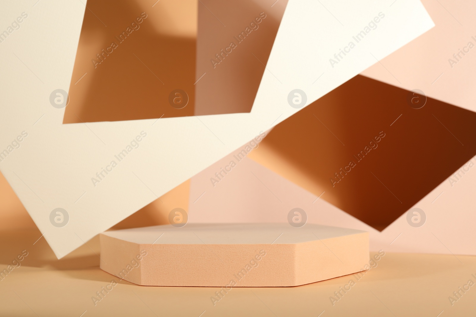 Photo of Presentation of product. Podium and paper on orange background