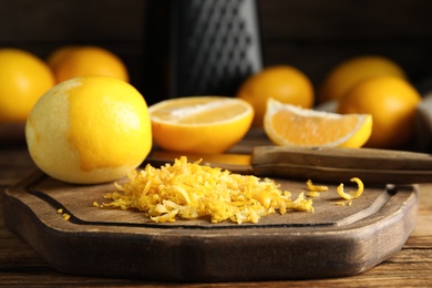 Lemon zest and fresh fruits on wooden table, closeup