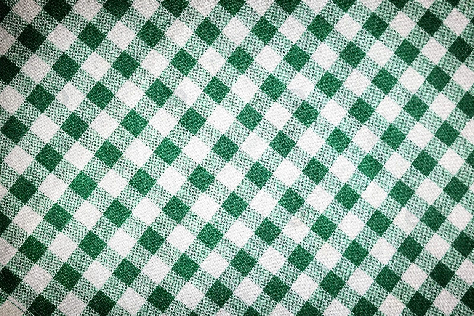 Image of Green and white tablecloth as background, vignette effect