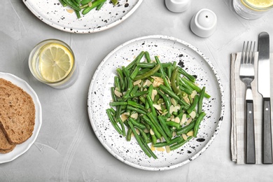 Tasty green beans with almonds served for dinner on table, top view