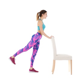 Photo of Young woman exercising with chair on white background. Home fitness