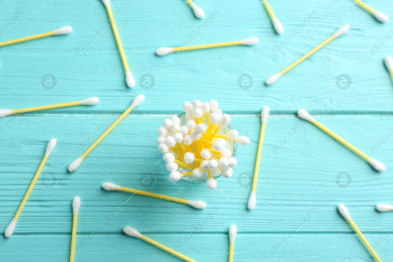 Photo of Flat lay composition with cotton swabs on wooden background