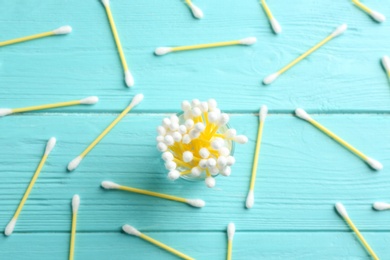 Flat lay composition with cotton swabs on wooden background