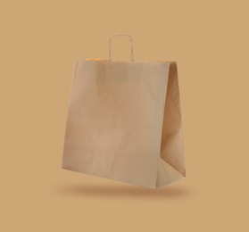 Image of Kraft paper bag on beige background. Mockup for design