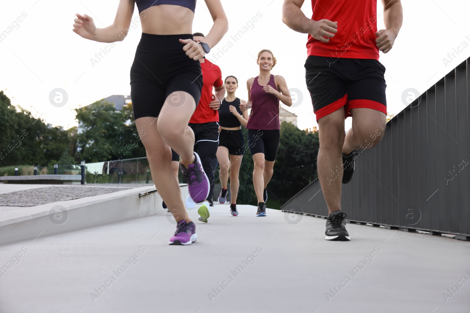 Photo of Group of people running outdoors. Active lifestyle