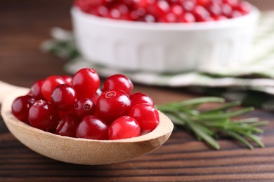 Photo of Fresh ripe cranberries on wooden table, closeup