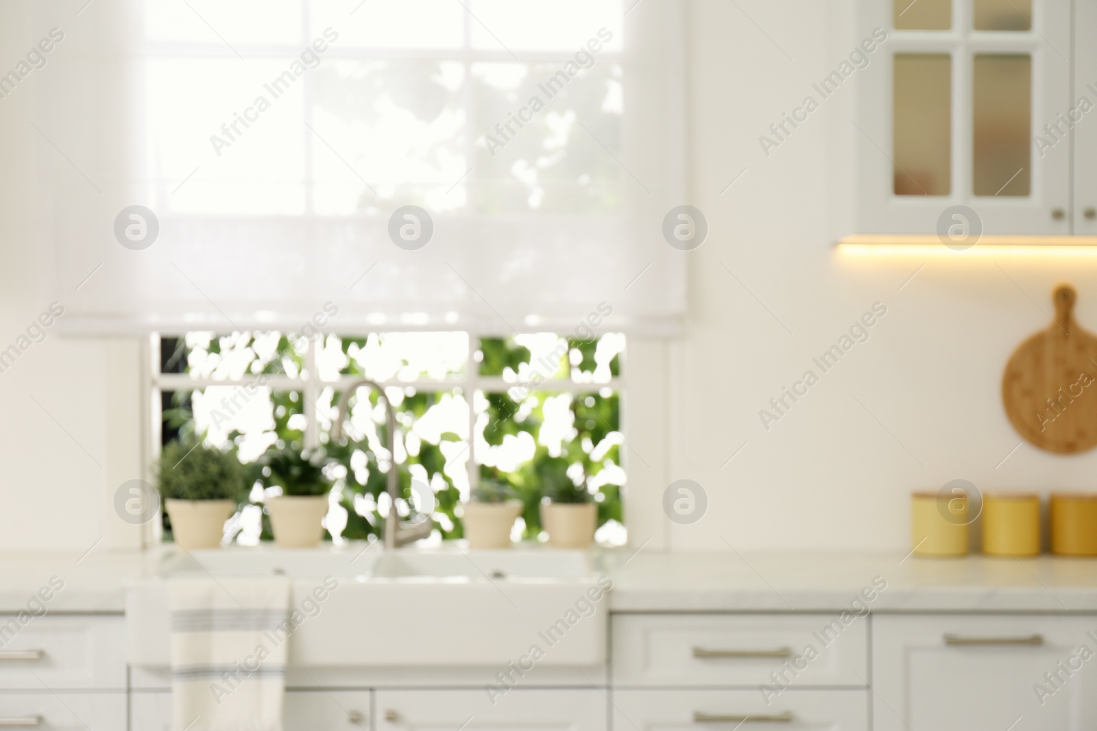 Photo of Blurred view of modern kitchen interior with stylish furniture