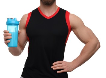 Young man with muscular body holding shaker of protein on white background, closeup