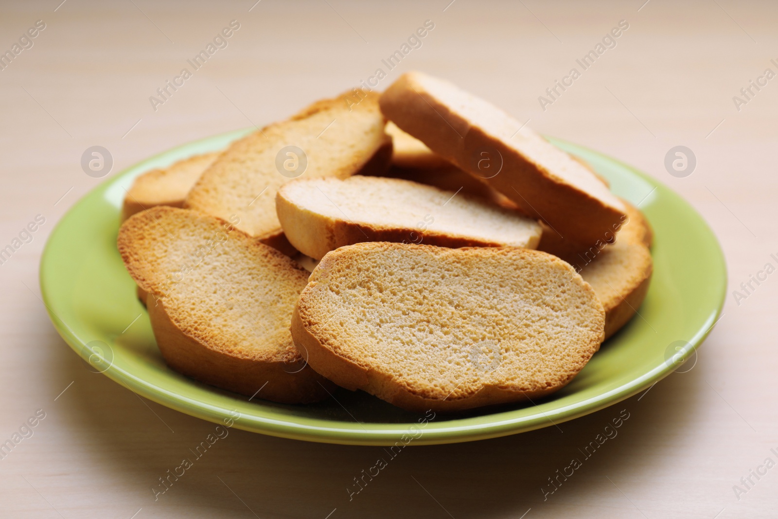 Photo of Plate of hard chuck crackers on wooden table