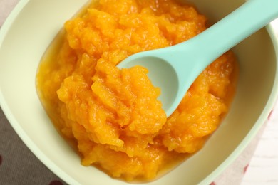 Photo of Baby food. Tasty pumpkin puree on white table, top view