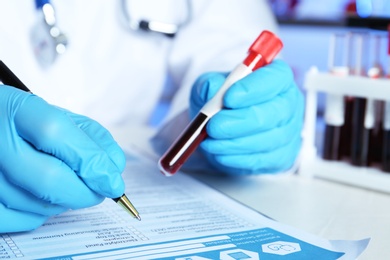 Photo of Scientist working at table in laboratory, closeup. Research and analysis