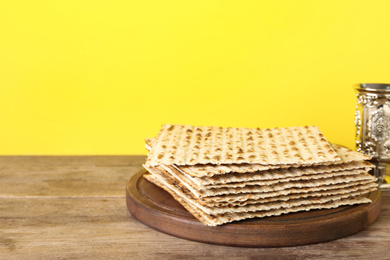 Photo of Passover matzos and silver goblet on wooden table, space for text. Pesach celebration
