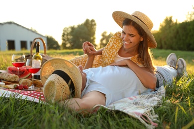 Photo of Happy couple having picnic in park on sunny day