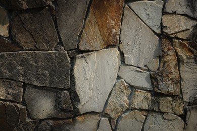Photo of Texture of dark stone wall as background