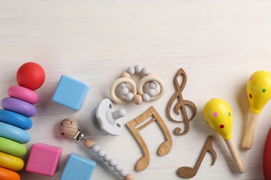 Photo of Baby song concept. Wooden notes, kids maracas and toys on table, flat lay. Space for text