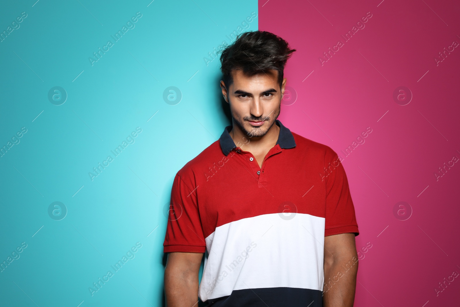 Photo of Young man with trendy hairstyle posing on color background