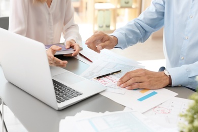 Tax accountants working with documents at table