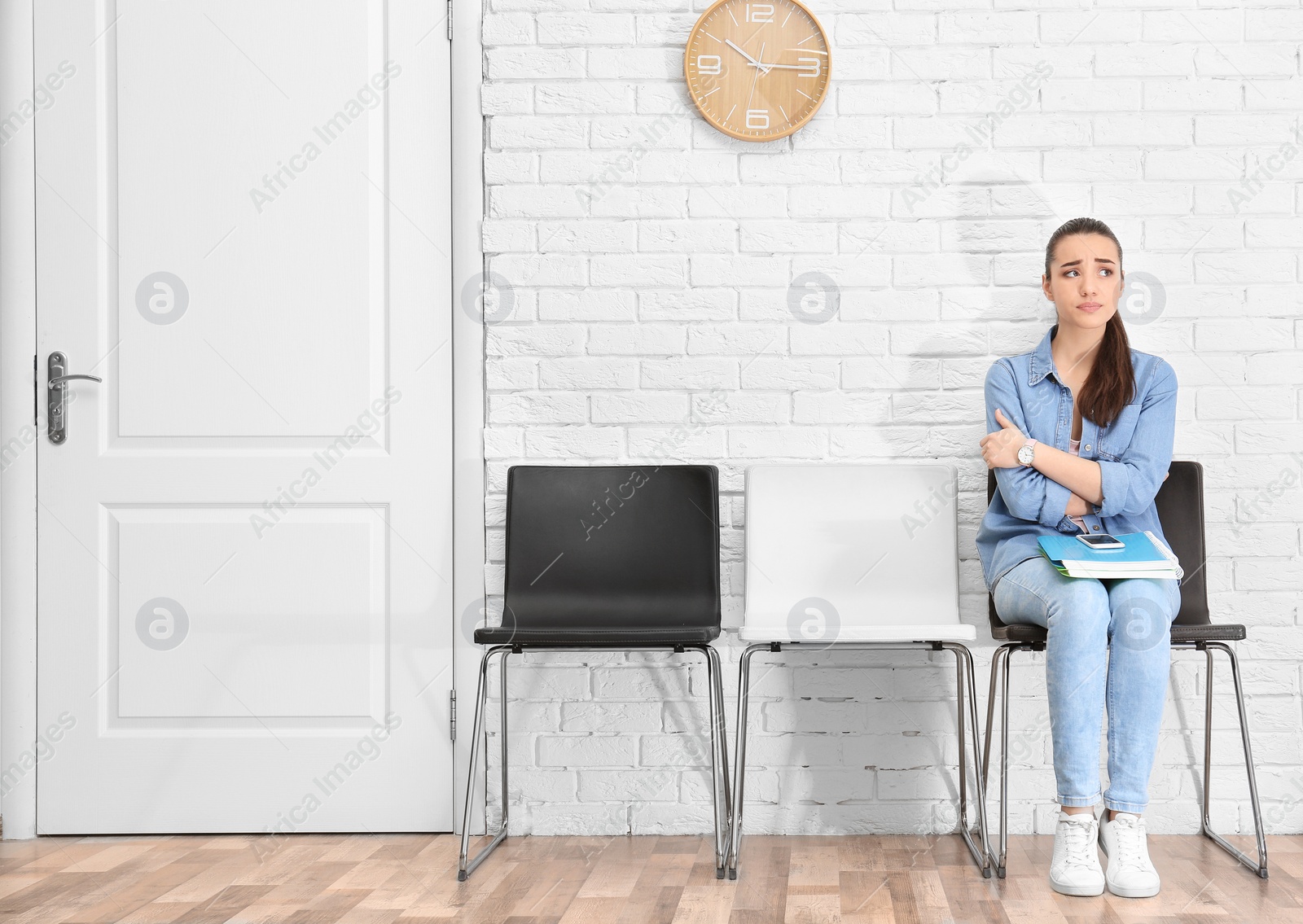 Photo of Young woman waiting for job interview, indoors