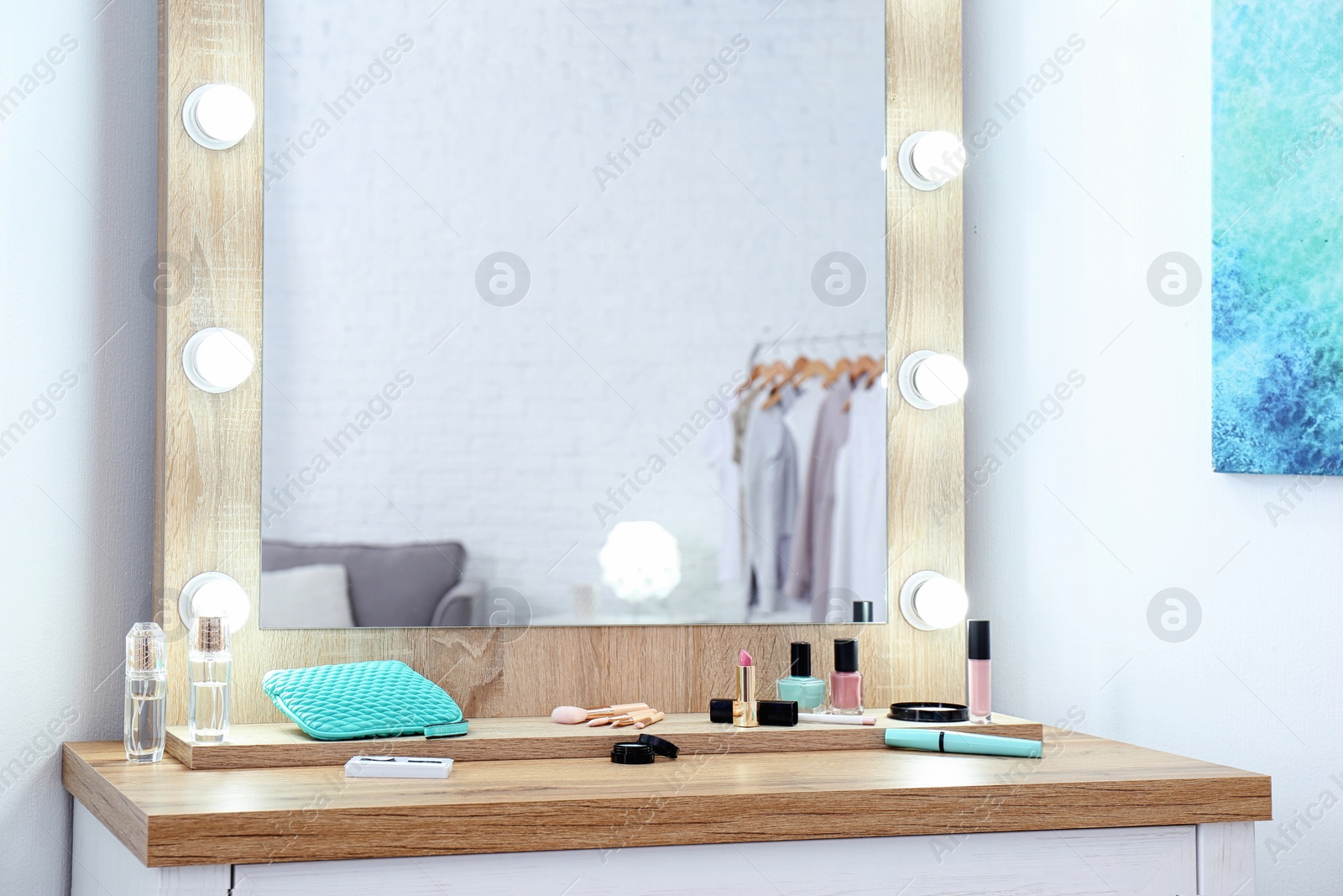 Photo of Makeup mirror on table near white wall in dressing room