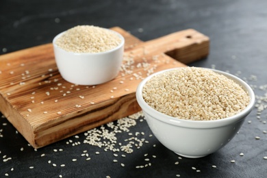 Photo of White sesame seeds on black slate table