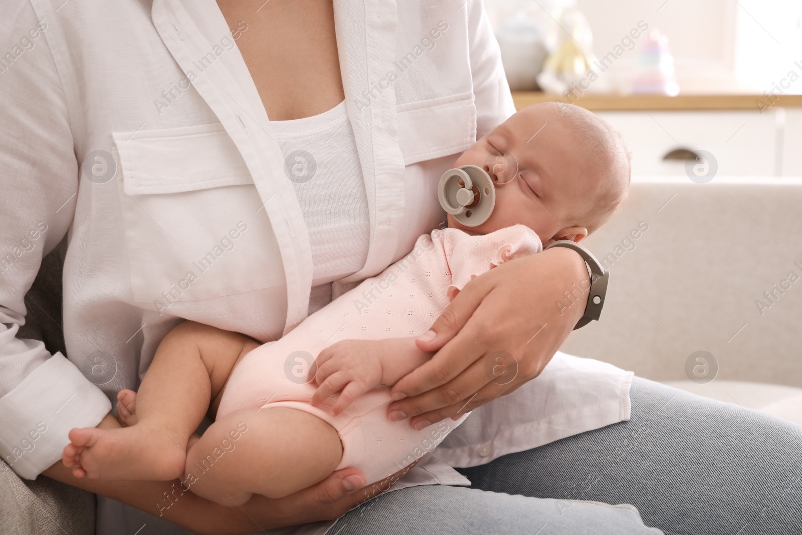 Photo of Mother with her cute sleeping baby at home, closeup