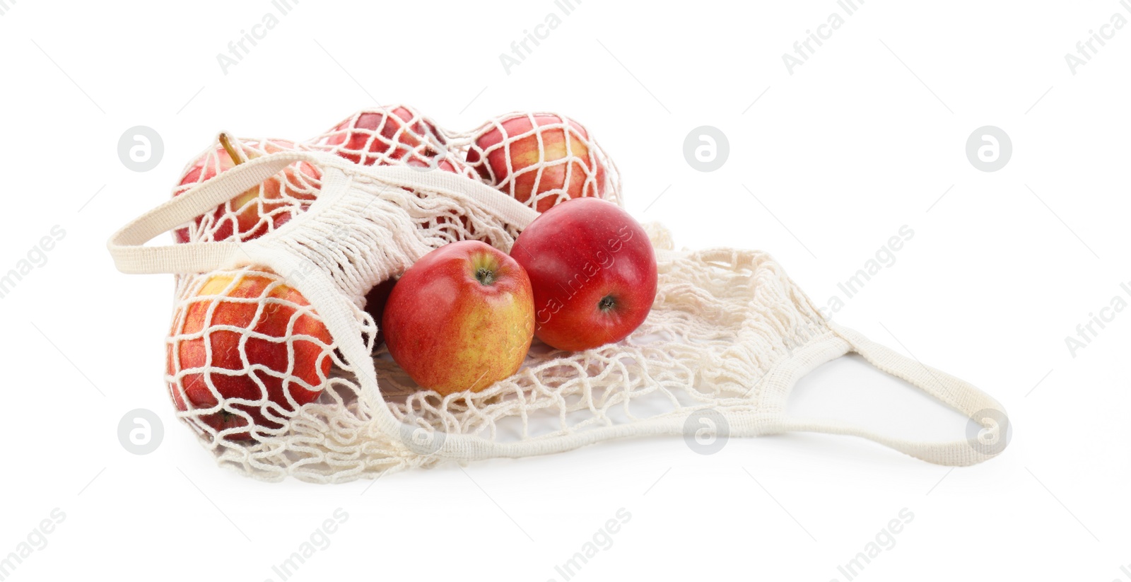 Photo of String bag with apples isolated on white