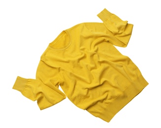 Photo of Warm yellow sweater on white background, top view