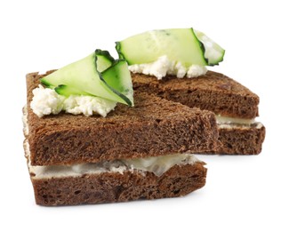 Tasty sandwiches with cucumber and cream cheese on white background