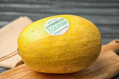 Whole ripe spaghetti squash on wooden board