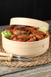 Delicious boiled crabs with lime and dill served on wooden table