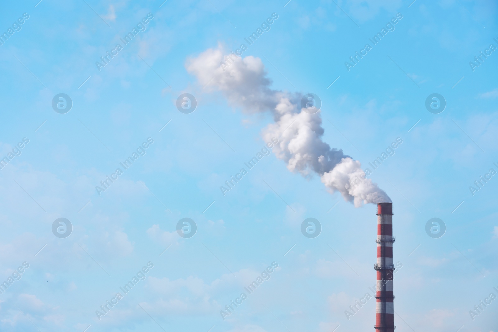 Photo of Polluting air with smoke from industrial chimney outdoors, space for text. CO2 emissions