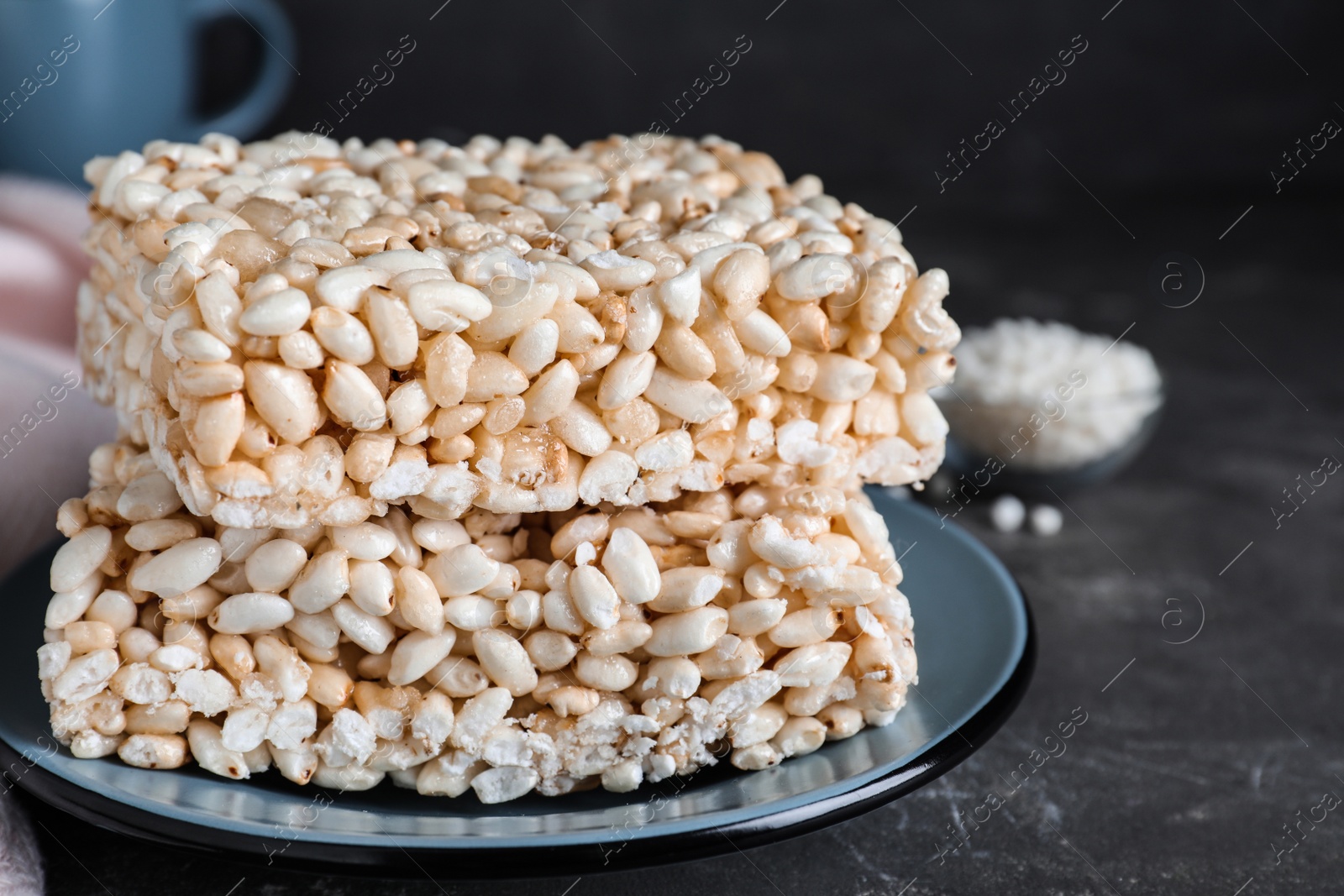 Photo of Delicious rice crispy treats on grey table, closeup