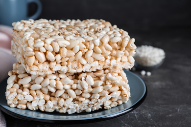 Photo of Delicious rice crispy treats on grey table, closeup